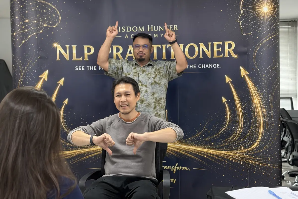 Adults participating in an experiential NLP classroom exercise in Malaysia
